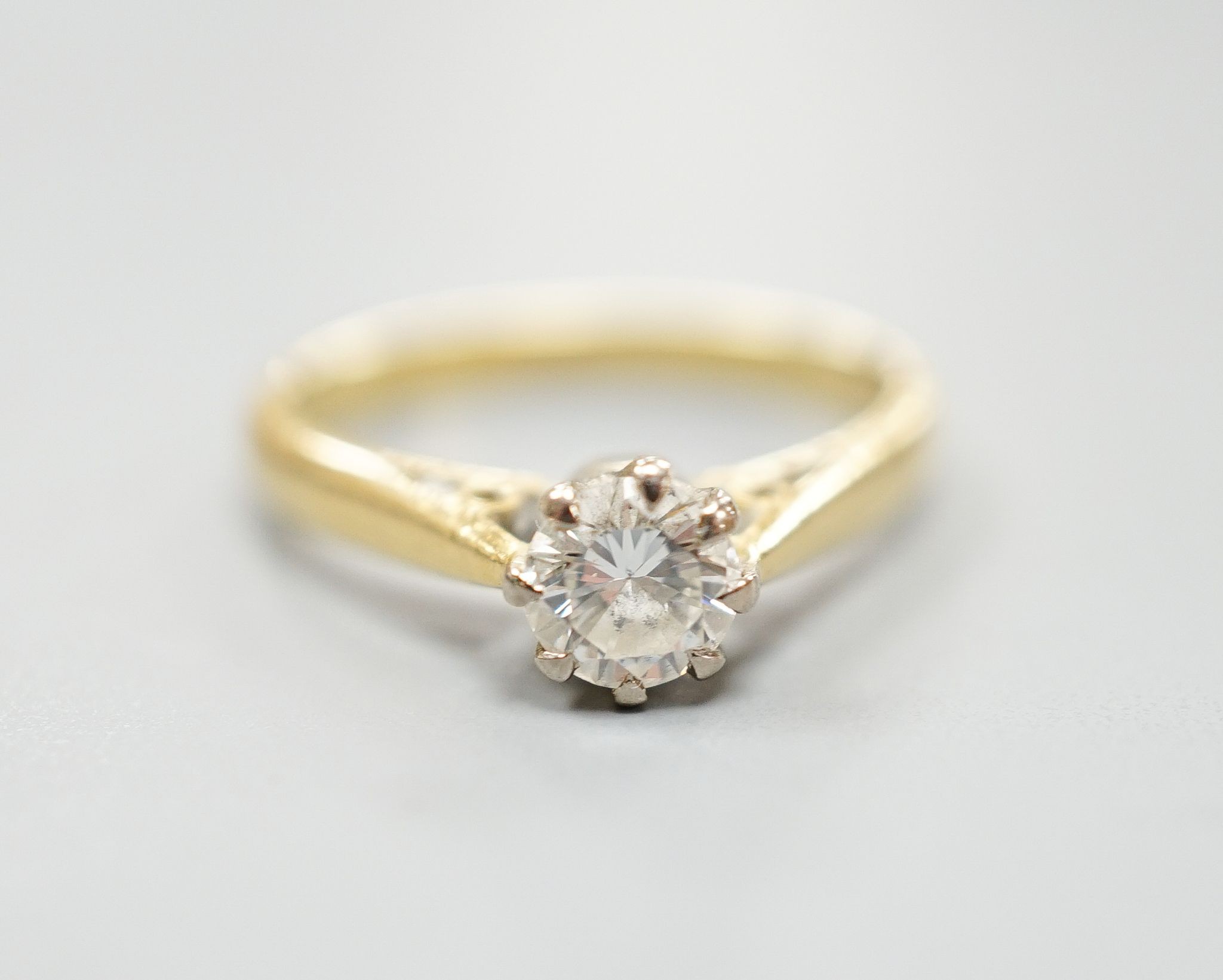 A modern 18ct gold and solitaire diamond ring, size N, gross weight 3.5 grams